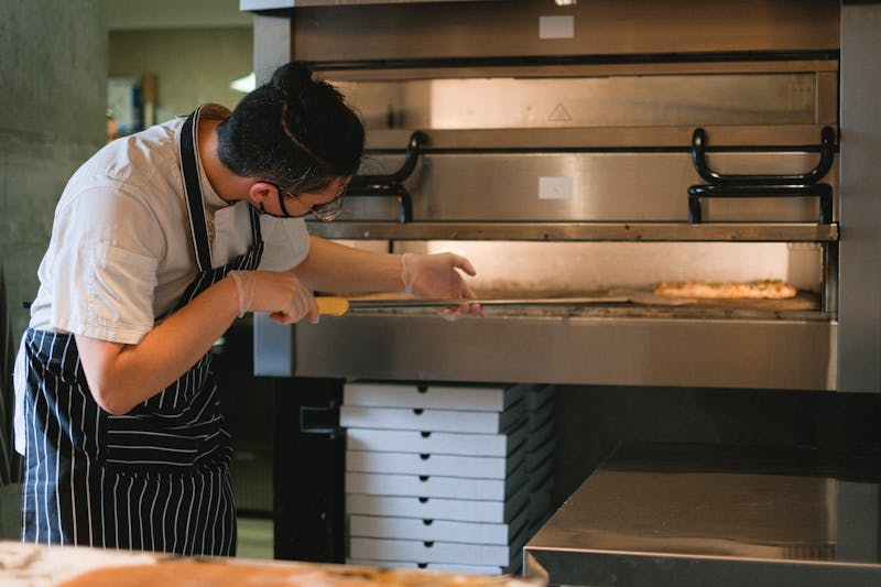 Jet's pizza team working together in the kitchen